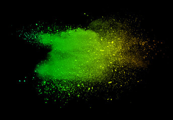 Abstract powder splatted background. Green powder explosion on black background. Colored cloud....