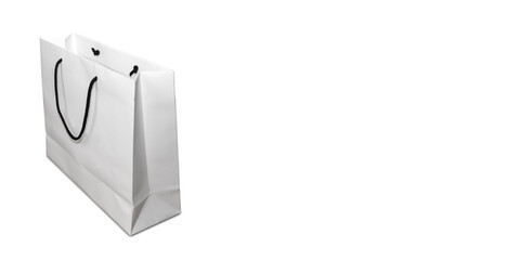 Empty white paper bag on white background with copy space. Delivery concept advertising mock.