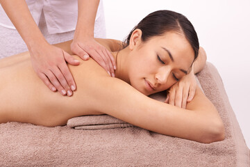 Obraz na płótnie Canvas Hands, wellness and woman with back massage at spa for health, self care and grooming treatment in studio. Skin, calm and female person with masseuse for body routine on table by white background.