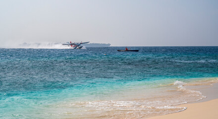 The seaplane takes off on the sea surface and swirls the water.