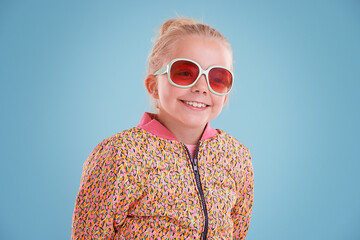 Happy, sunglasses and girl child in studio with funky, trendy and stylish jacket for outfit....