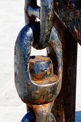 A link in the chain on a rusty industrial object close up view