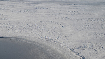 ice and snow covered lake surface in winter