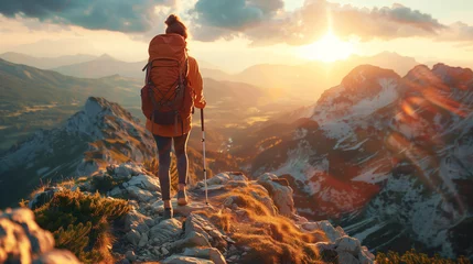 Deurstickers Hiker woman with backpack standing on top of mountain and looking at beautiful view during sunset, adventure concept, extreme sport activities or nature exploration. © Ratthamond