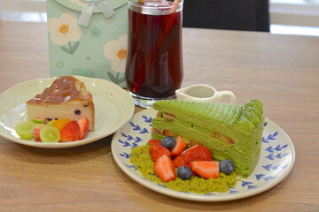 Matcha strawberry layer cake with fresh muscadines and blueberries, Basque cheesecake and fruit tea