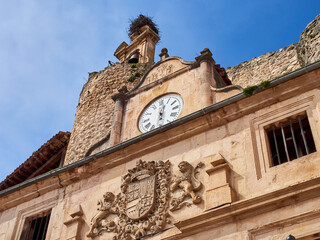 Bell gable and stone building with a clock in the main square (Plaza Mayor in Spanish) of Sepulveda, province of Segovia. Castilla y León, Spain, Europe