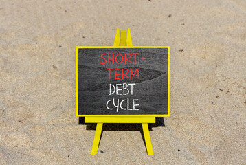 Short-term debt cycle symbol. Concept words Short-term debt cycle on beautiful black chalk blackboard. Beautiful sand beach background. Business Short-term debt cycle concept. Copy space