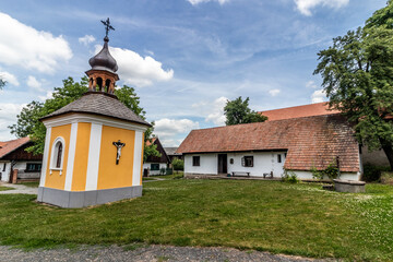 Naklejka premium Old houses and a chapel in the open air museum (Polabske národopisne muzeum) in Prerov, Czechia