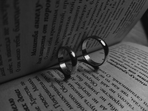 Photo of wedding rings on a book.