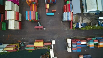 Big fork lift unloading a large container from a truck, in a big container port in Copenhagen, Denmark. The truck drives away after unload - Powered by Adobe