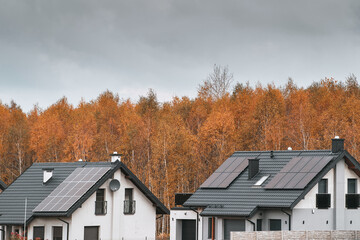 A Modern House with Photovoltaic Panels on the Roof. The House Uses Solar Energy to Generate Electricity and Reduce Environmental Impact.