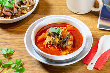 Red soup with seaweed, tomato and tofu. Chinese food.