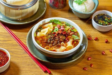 Noodle soup with peanuts, green onions and cabbage. Chinese food.