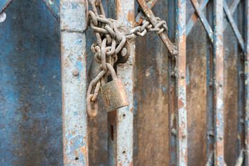 Old rusty chain and lock in selective focus for background content
