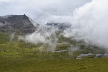 The dramatic coastline and green mountains of the Faroe Islands