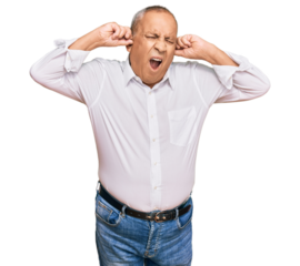 Handsome senior man wearing elegant white shirt covering ears with fingers with annoyed expression for the noise of loud music. deaf concept.