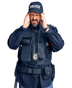 Young handsome man wearing police uniform with hand on head, headache because stress. suffering migraine.