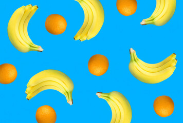 Banana and orange on the blue background. Flat lay. Top view.