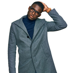 Young african american man wearing business clothes and glasses confuse and wondering about...