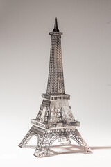 Delicate metal Eiffel Tower model on white background