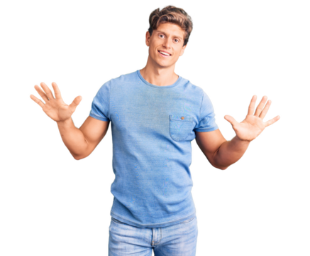 Young handsome man wearing casual clothes showing and pointing up with fingers number ten while smiling confident and happy.