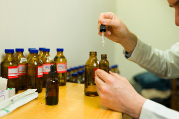 Close up of a doctor preparing homeopathy medicine