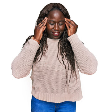 Young african woman wearing wool winter sweater with hand on head, headache because stress. suffering migraine.