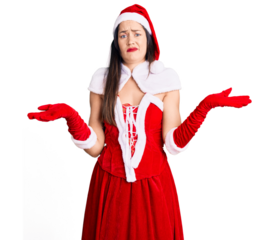 Young beautiful caucasian woman wearing santa claus costume clueless and confused with open arms, no idea concept.