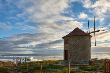 Windmills along the coastal path, Praia da Apulia beach, Portugal. © Uvamenfoto