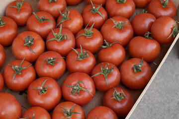 Tomatoes lying on a pile on top of each other, tomato texture. .