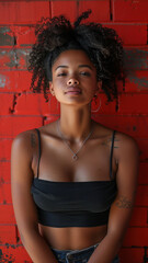 Portrait of African attractive woman against background of red brick wall