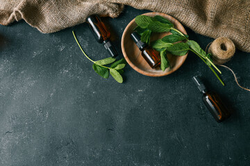 Set of natural cosmetics with mint on wooden background