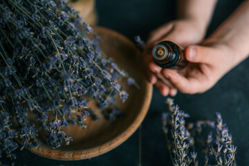 Essential oil with lavender extract in hands