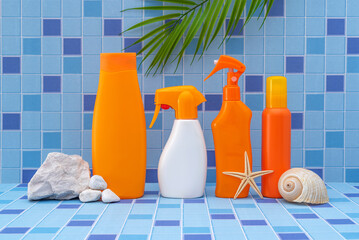 SPF. The bottles of sunscreen in the bathroom are decorated with seashells. UV protection. Blue...