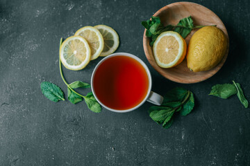 Glass cup with hot tea and lemon on table