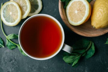 Glass cup with hot tea and lemon on table