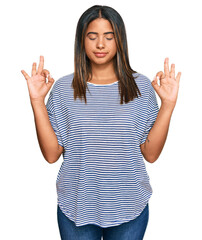 Young latin girl wearing casual clothes relax and smiling with eyes closed doing meditation gesture with fingers. yoga concept.