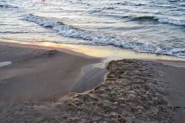 Sunset beach sand and sea wave close up. - 765804898
