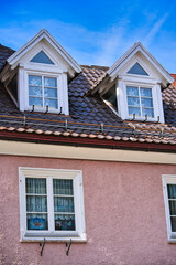 typical dormer windows of a German town on a pitched roof and tiles