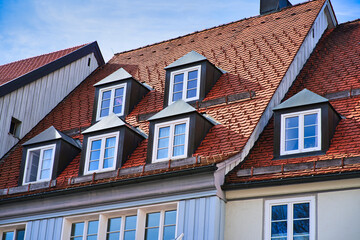 typical dormer windows of a German town on a pitched roof and orange tiles
