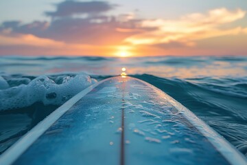 Surfboard on calm sea at sunset, tranquil moments before riding waves. - obrazy, fototapety, plakaty
