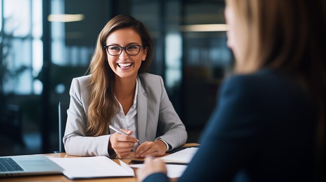 This image captures a professional scene in an office where a smiling female financial advisor, attorney, or bank manager is engaged in a business meeting with a client.  