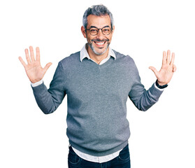 Naklejka premium Middle age hispanic with grey hair wearing glasses showing and pointing up with fingers number nine while smiling confident and happy.