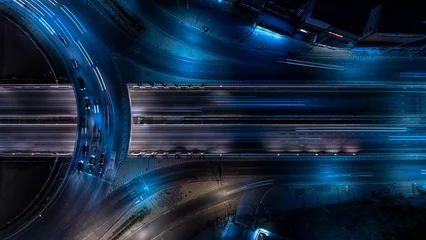 Fotobehang Expressway top view, Road traffic an important infrastructure, Drone aerial view fly in circle, traffic transportation, Public transport or commuter city life concept of economic and energ, transport. © suriyapong