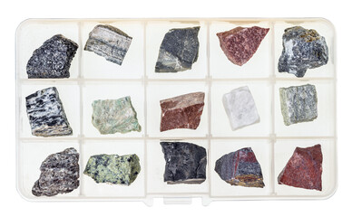 top view on natural raw rocks for geological collection in open plastic box with cells isolated on white background