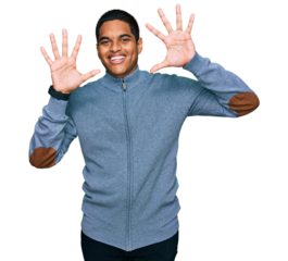 Young handsome hispanic man wearing casual sweatshirt showing and pointing up with fingers number ten while smiling confident and happy.