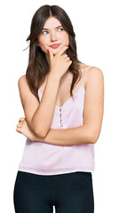 Young beautiful caucasian girl wearing casual clothes with hand on chin thinking about question, pensive expression. smiling with thoughtful face. doubt concept.