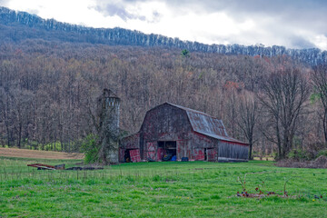 Old rustic red barn in the mountains