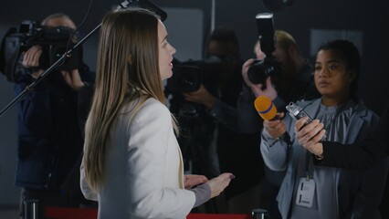 Confident female EU Representative or consul answers journalists questions on press conference,...
