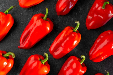 ripe sweet red pepper on dark background pattern 